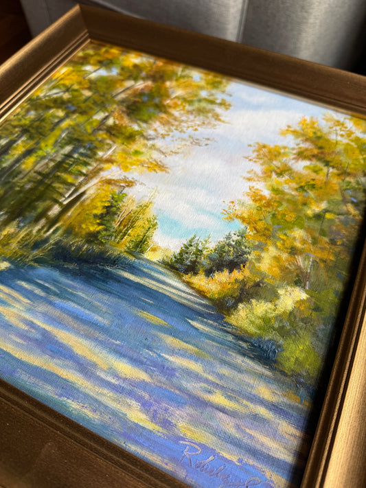 Framed painting of a landscape with trees and shade.